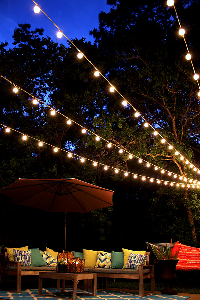 Setting up string lights in deals backyard